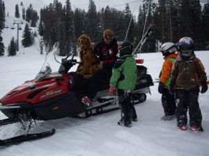 Arapahoe Basin Ski Patroller, Tony C, and Avalanche Rescue Dog, Ruby, catching up with Kids Club Arapahoe skiers. 